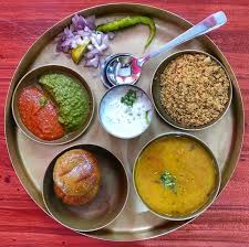 Thali ( dal , bati , salad , chutney , achar , masala chach )
