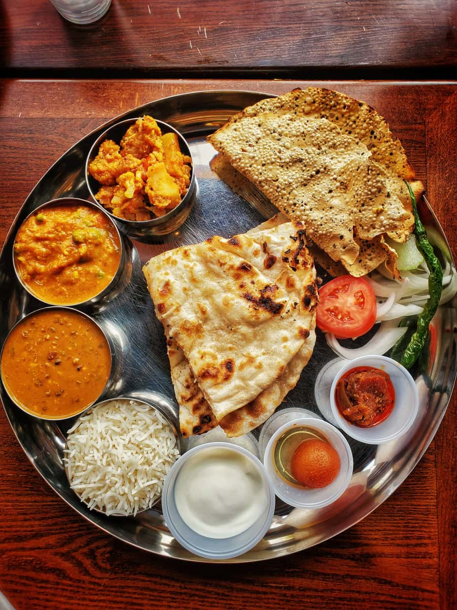 Thali (1 Lachcha, 2 Roti, Dal, Rice, Paneer, Salad, Sweet, Papad)
